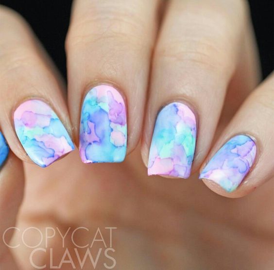 a pink, blue, and purple watercolor nail design that matches fin fun's watercolor waves mermaid tail