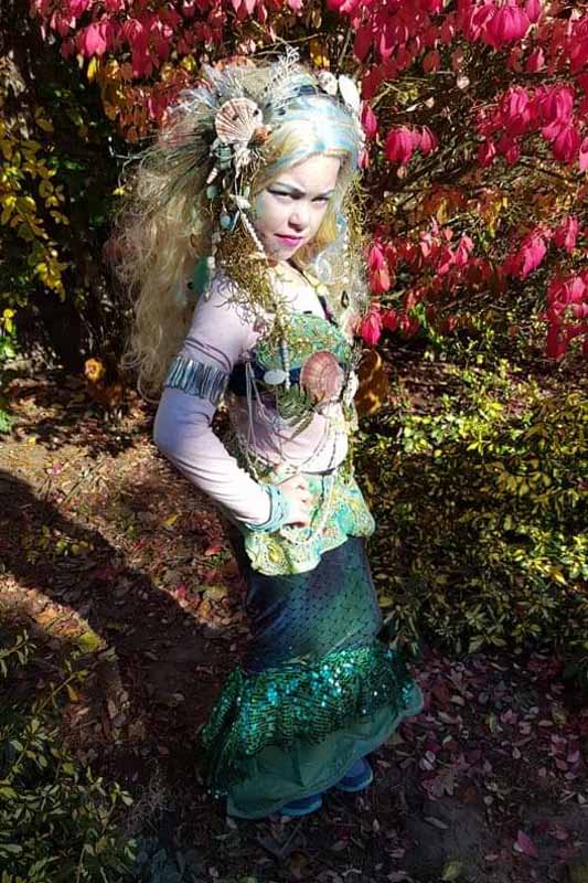 a girl in an intricate mermaid costume