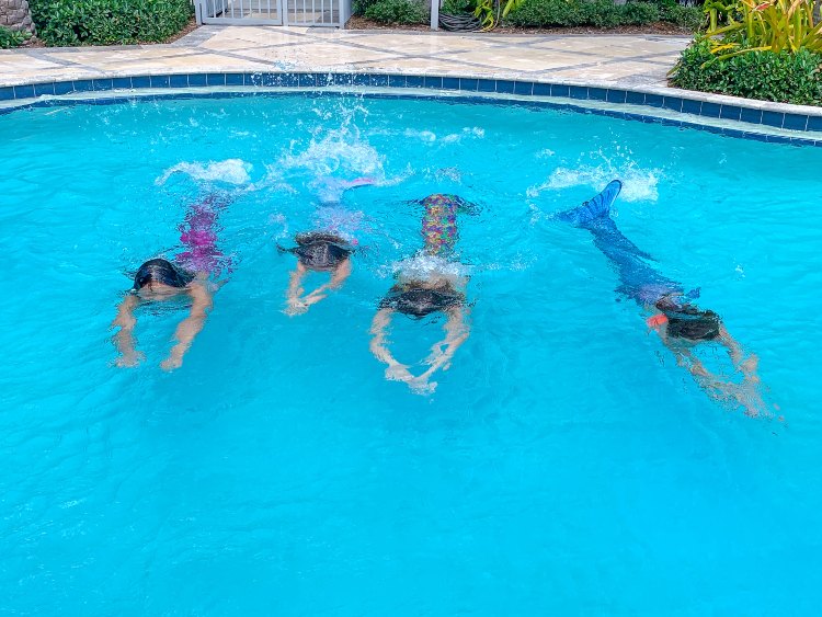 girls swimming in mermaid tails