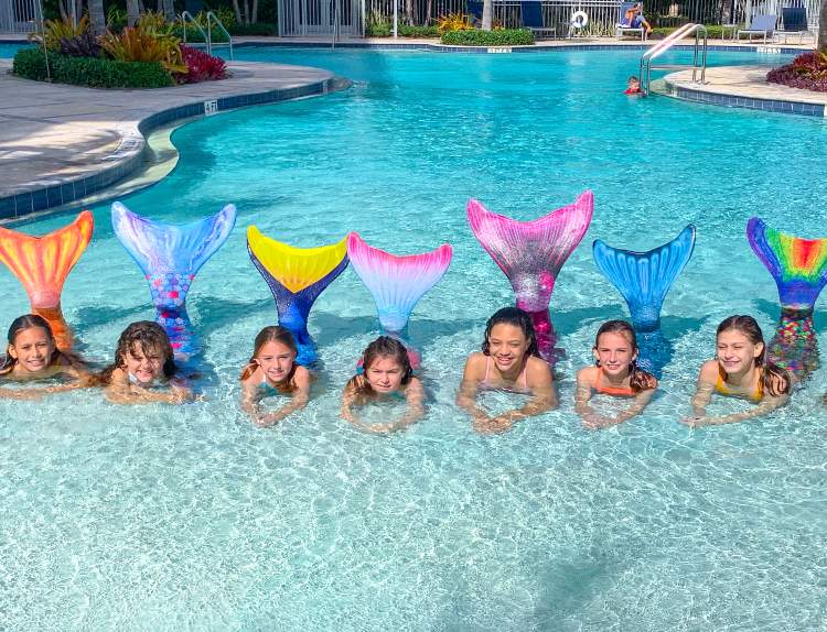 a mermaid U class posing in a pool