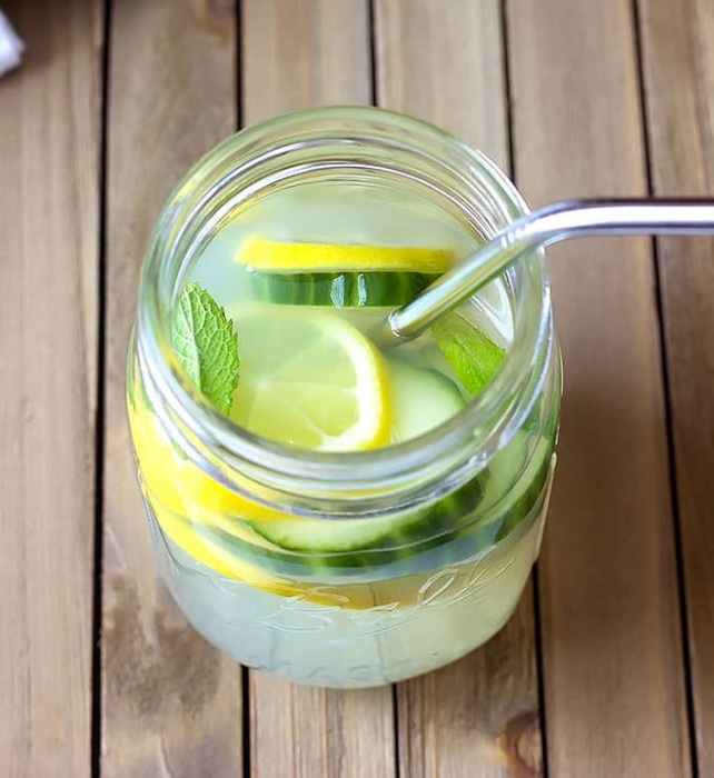 cucumber mint lemonade in a glass jar with a metal straw