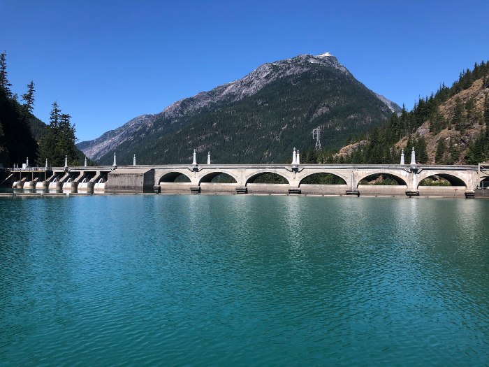 a dam with mountains in the background