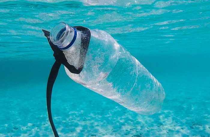 a discarded plastic water bottle floating in the ocean