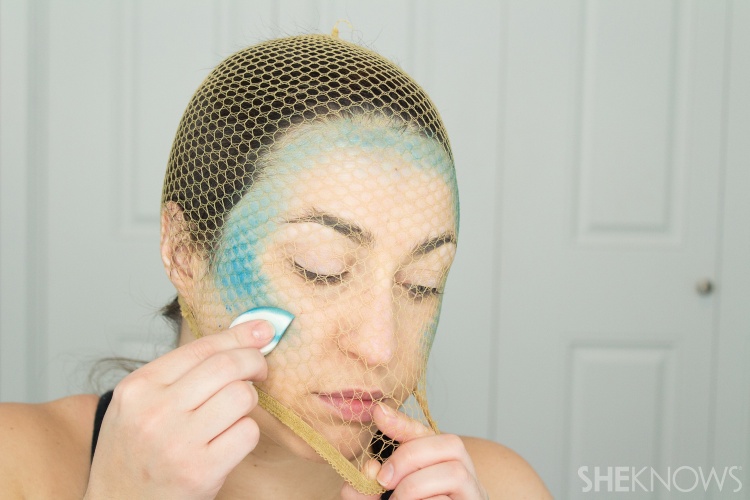 woman applying mermaid makeup with fishnets