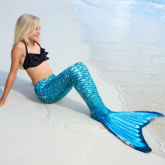 girl sitting on the beach in the Tidal Teal Mermaidens tail