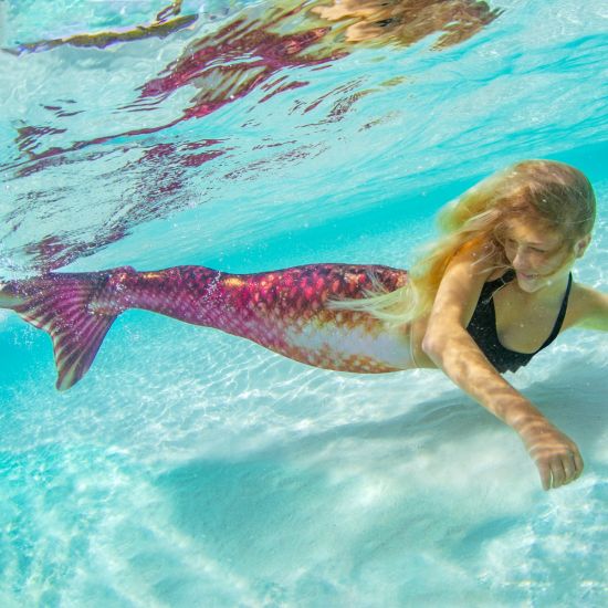 girl swimming underwater in the Bronzed Ruby Limited Edition mermaid tail