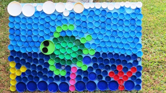 a sea turtle mosaic made with multi-colored plastic bottle caps