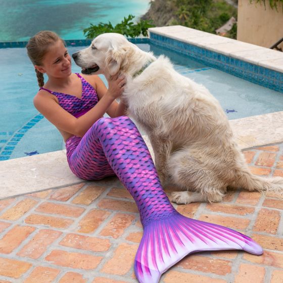 girl in the Asian Magenta mermaid tail and scale bikini petting a dog