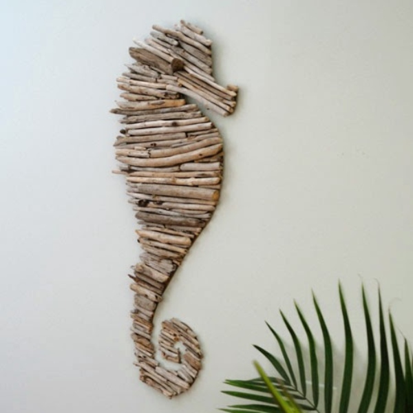 a wall hanging that features driftwood pieces arranged in the shape of a seahorse