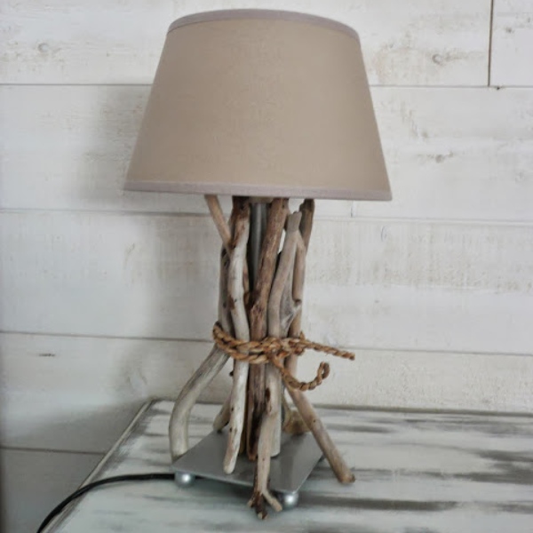 a plain lamp decorated with driftwood and rope