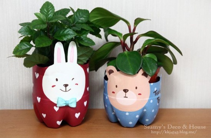 two plant pot plastic bottle crafts that have been painted to resemble a bunny and a bear