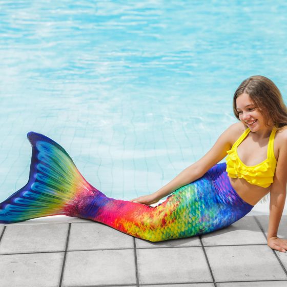 a girl posing poolside in the Amazon Rainforest mermaid tail, a retro mermaid tail with a watercolor rainbow effect