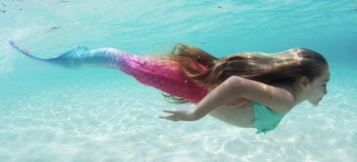a girl swimming underwater in the Bahama Blush mermaid tail