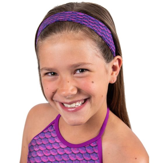 A smiling girl wears the Asian Magenta purple scale headband.