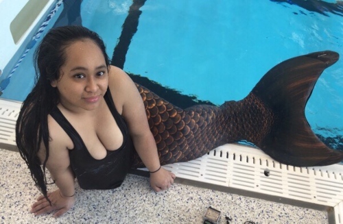Contest winner Savy poses poolside in a mermaid tail